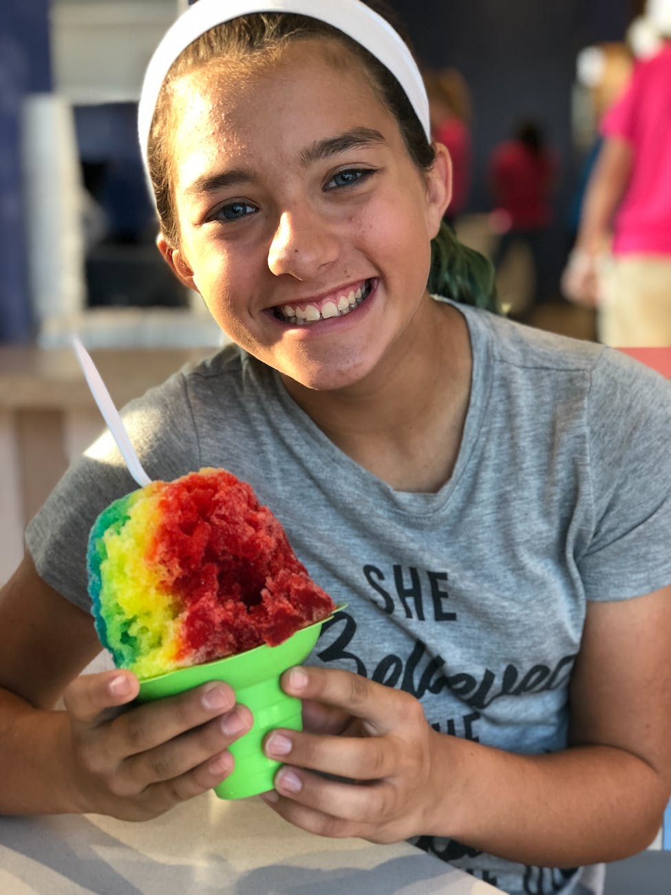 girl sitting on chair while holding ice cream