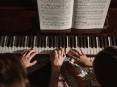 couple playing on piano