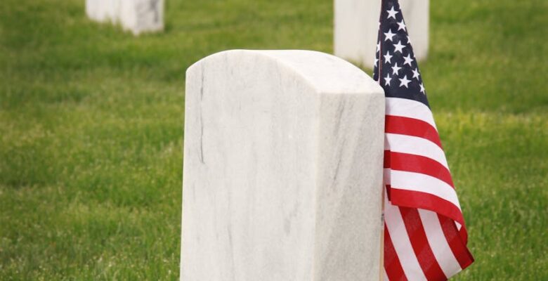 flag of u s a standing near a tombstone