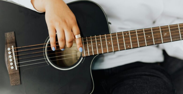 a person strumming the black guitar