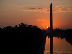 silhouette of tower during orange sunset