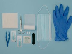 a set of first aid kit tools on blue surface