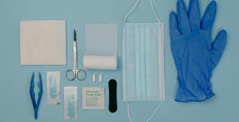 a set of first aid kit tools on blue surface